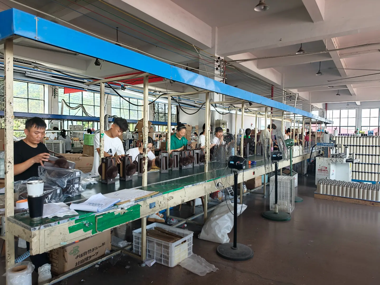 Workers handling products along a production line at a long-term MOWXI manufacturing partner facility