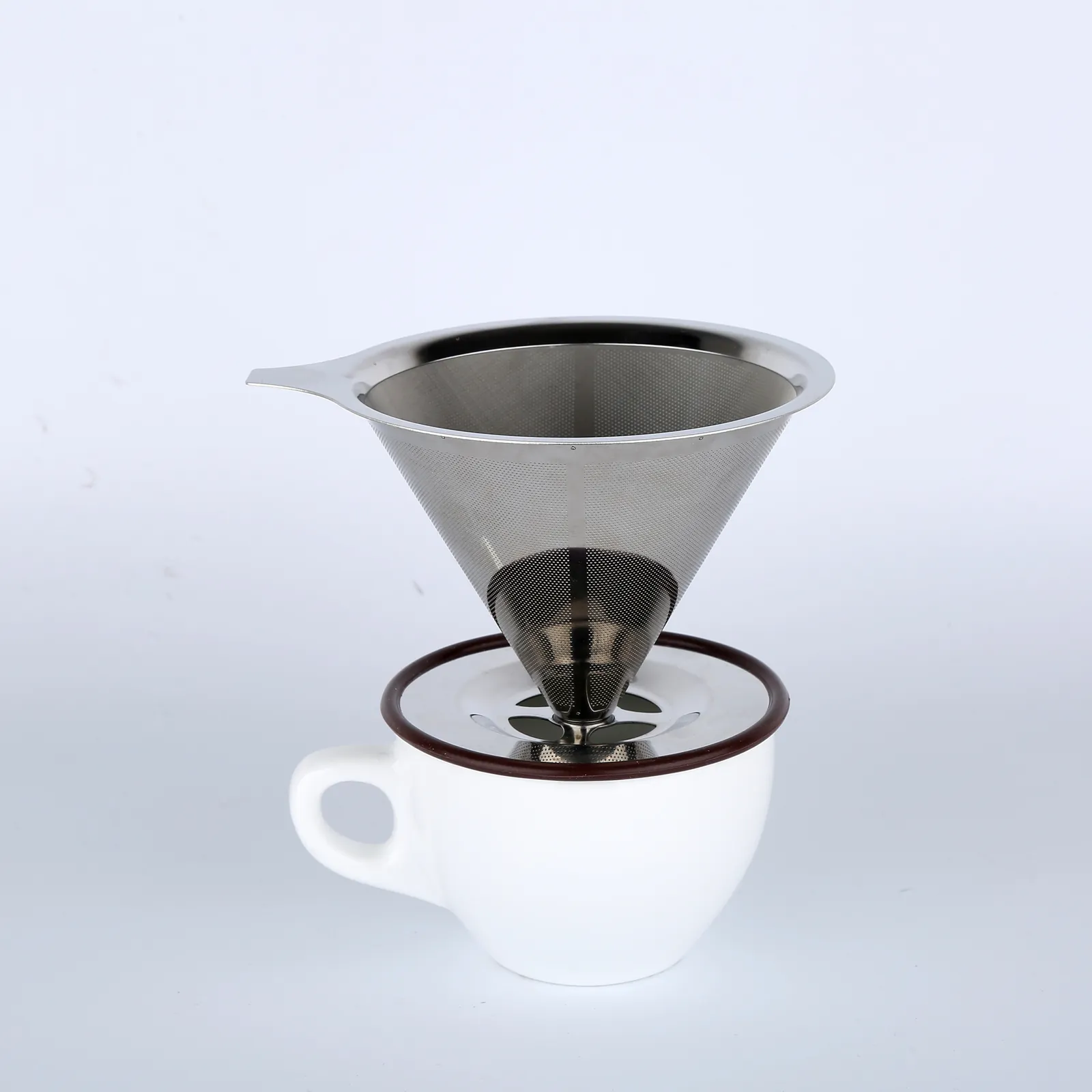 A stainless steel cone coffee filter (MX-CF01) sitting on a white ceramic mug.