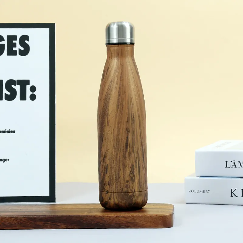 A 500 ml Stainless Steel Water Bottle (MX-WB01) with a wood-grain finish standing on a wooden base.