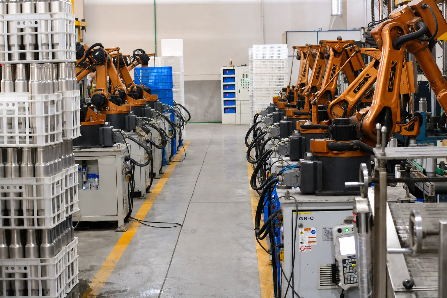 Industrial robotic arms at a long-term MOWXI manufacturing partner facility